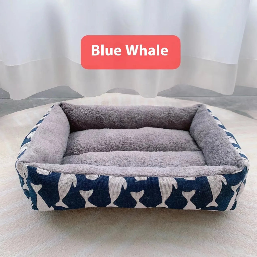 Moisture-proof linen dog bed in blue whale colour, rectangular shape with pillow, on floor.