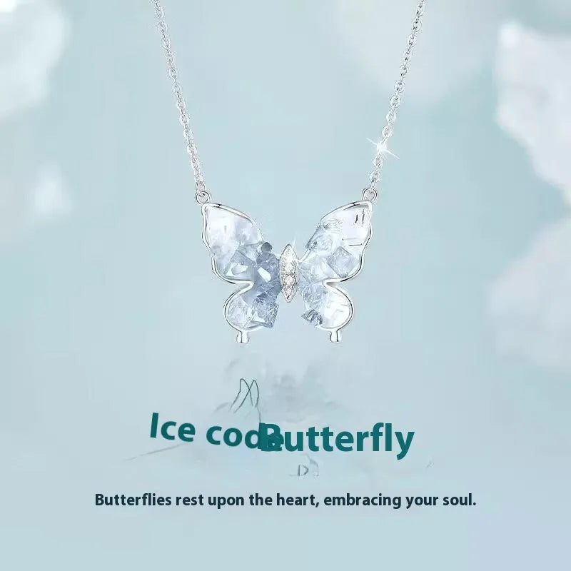 Close-up of a silver butterfly pendant on an adjustable O-ring chain, showing detailed wings and a 41-50 cm length.