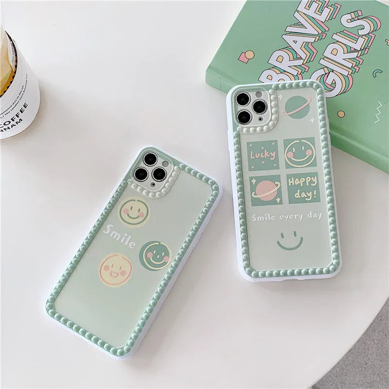 Green TPU iPhone case with geometric smiley face design and polka dot frame.
