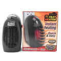 Small black ceramic electric heater with digital display and a rotating plug on a desk.