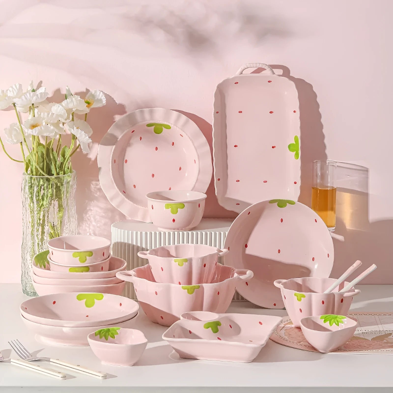 Strawberry-themed porcelain dinnerware set with plates, flower bowls, and microwave-safe spoons