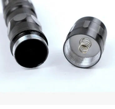 Small black aluminium LED flashlight showing scale and size.
