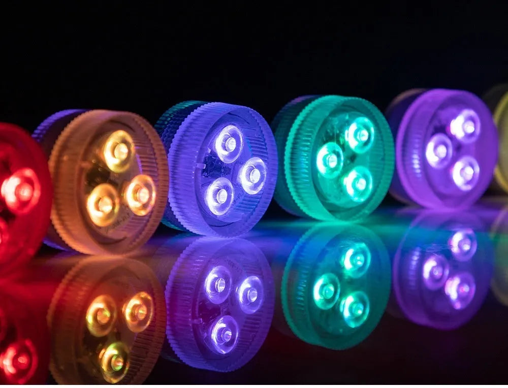 Compact white submersible aquarium LED light with remote control on a blue background