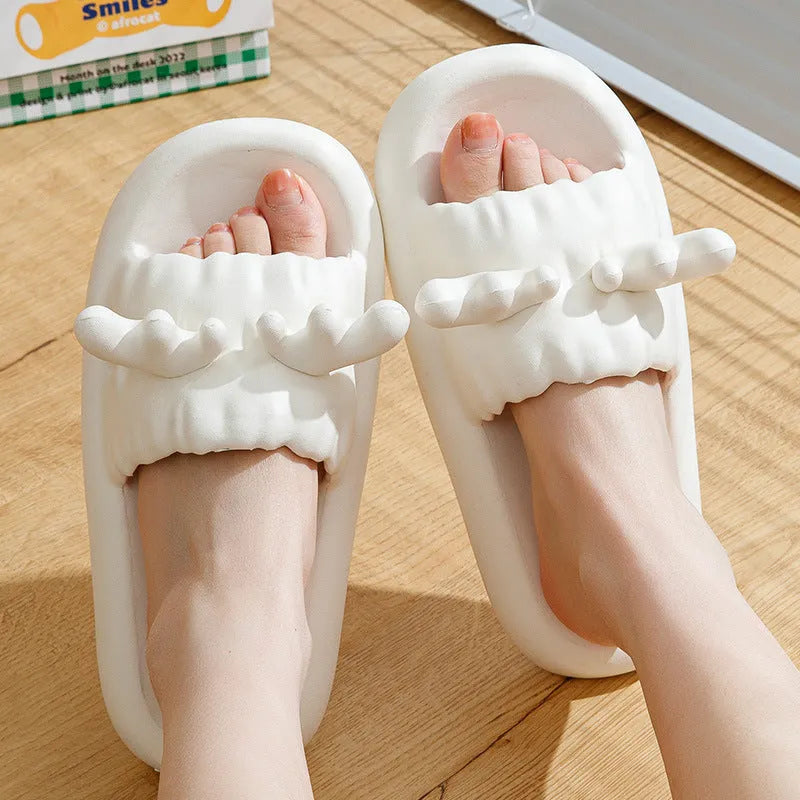 Women's deer horn design flip flop slippers in light yellow on a white background.