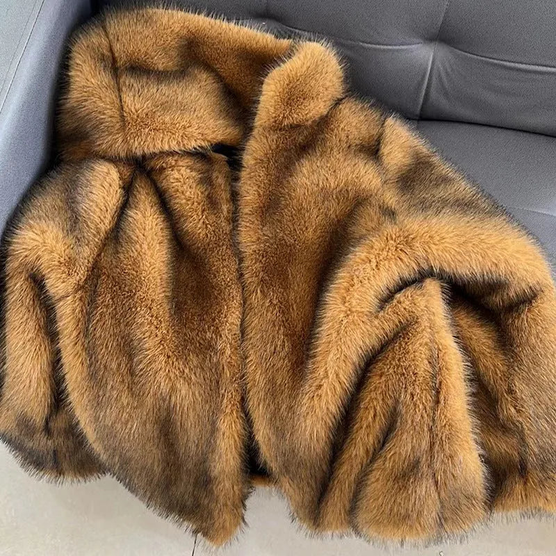 Women's silver grey artificial fur mid-length coat with a loose fit on a hanger.