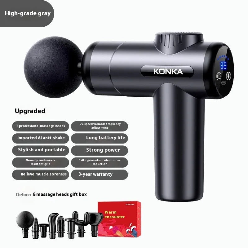 Konka V19 grey percussion massage gun with set of interchangeable foam and silicone massage heads on a table.