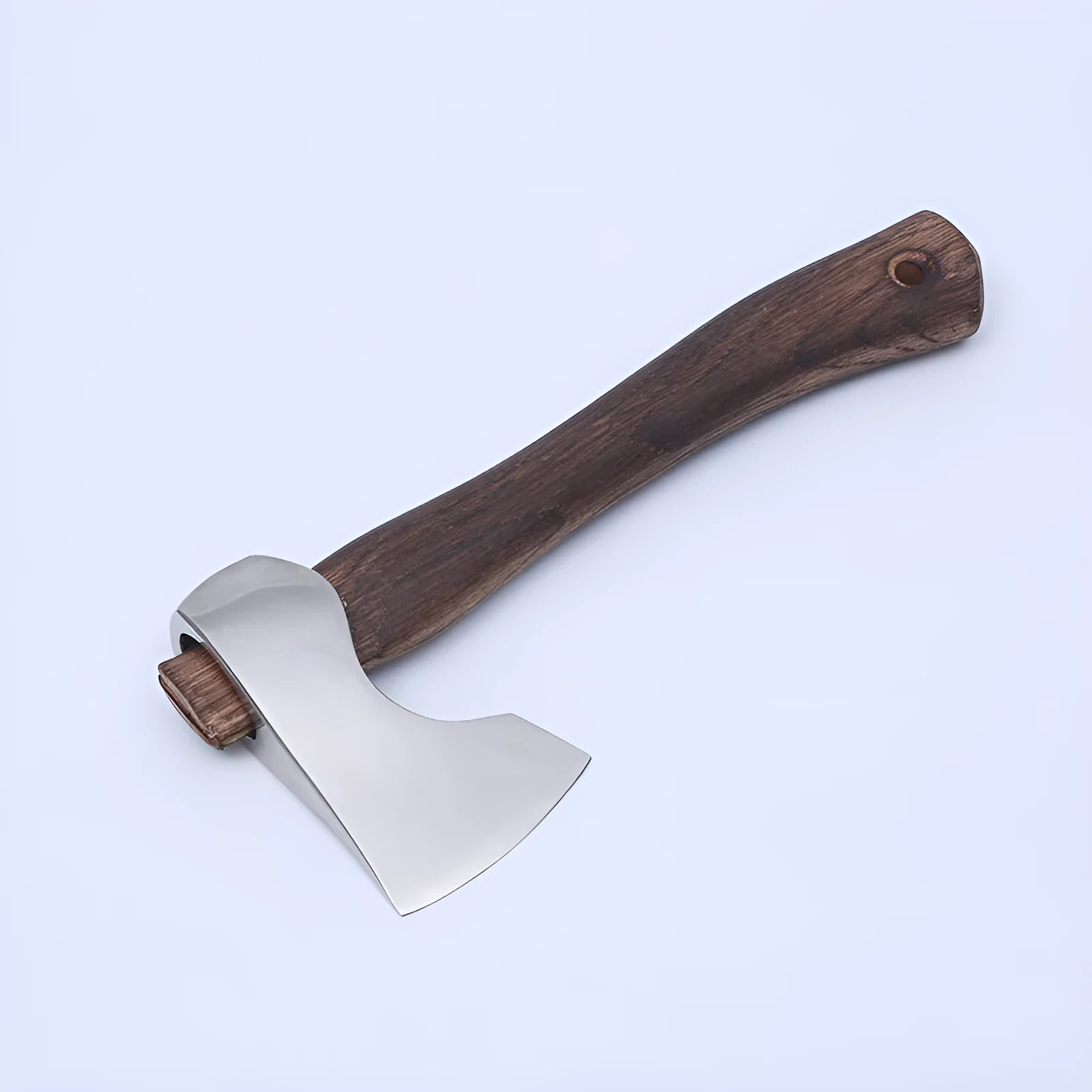 Compact camping axe with a wooden handle and high carbon steel head on a neutral background.
