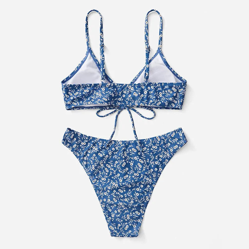 Blue women's swimsuit three-piece set featuring a top and shorts, made from polyester fabric.