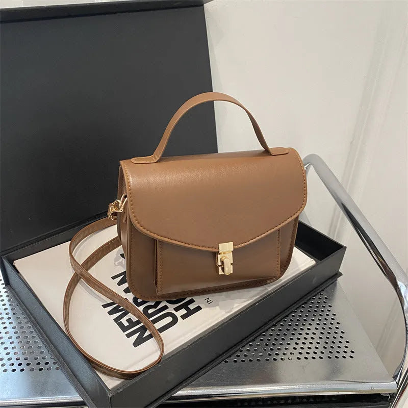 Horizontal square PU leather messenger bag in urban style with crossbody strap and sewing line detail.