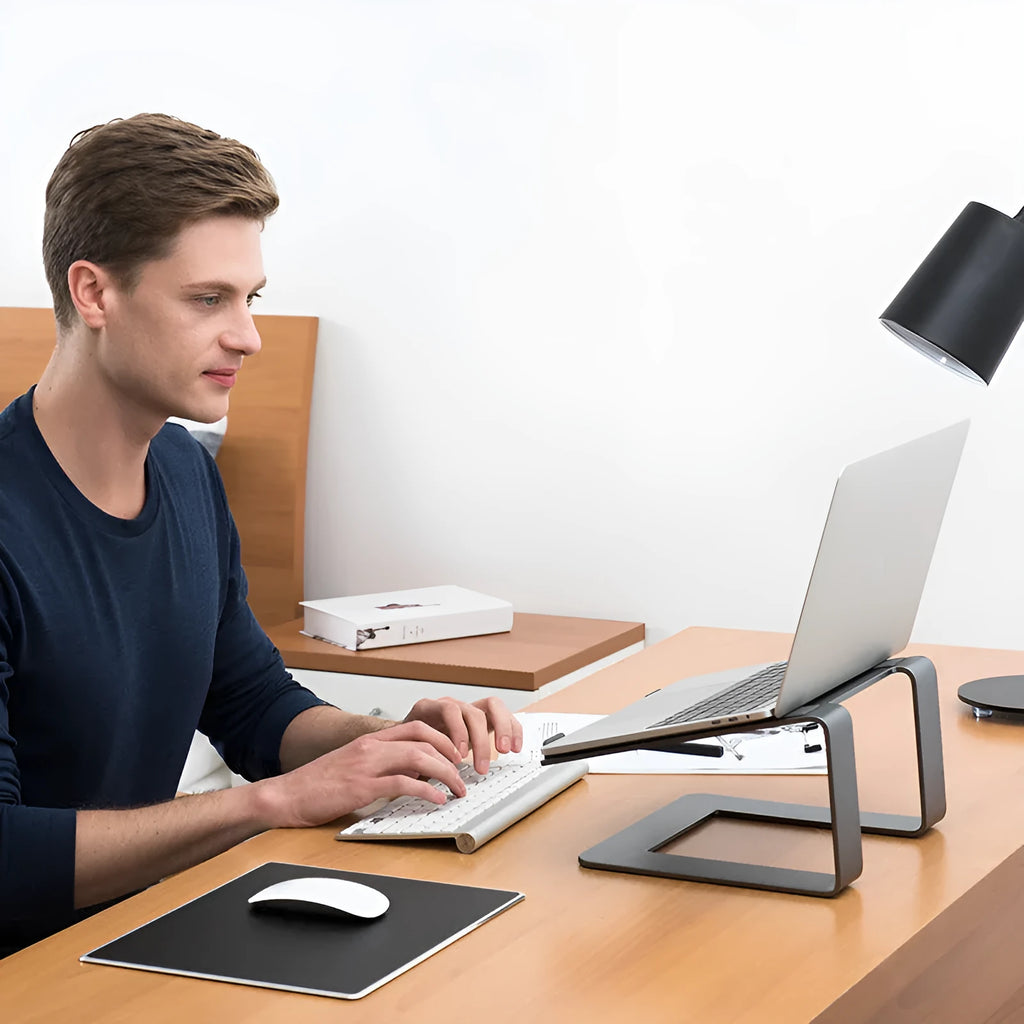 Black aluminium alloy laptop stand on desk showing dimensions and open-frame design