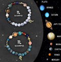 Set of twelve natural stone bead bracelets on a table, each with different coloured beads representing zodiac signs, showing adjustable cotton cord.
