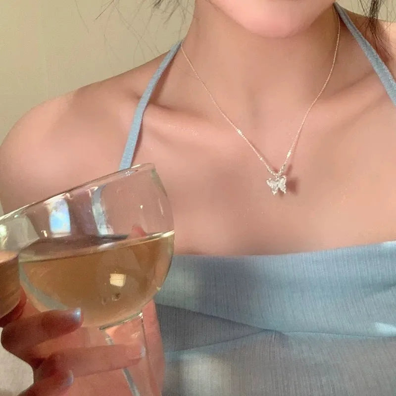 Silver women's butterfly necklace with square line opal pendant on an adjustable cross chain.