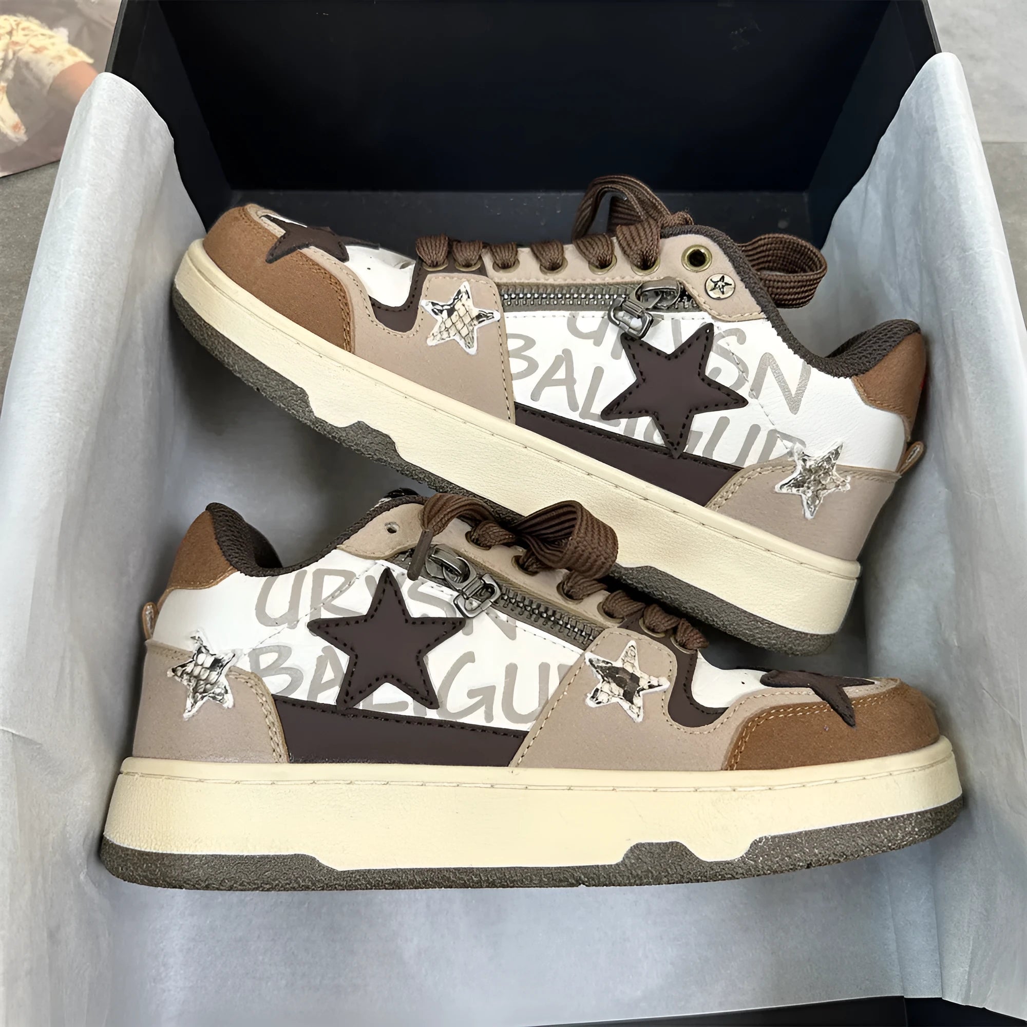Brown candy colour low-top sneakers with rubber sole and lace-up front on a neutral background