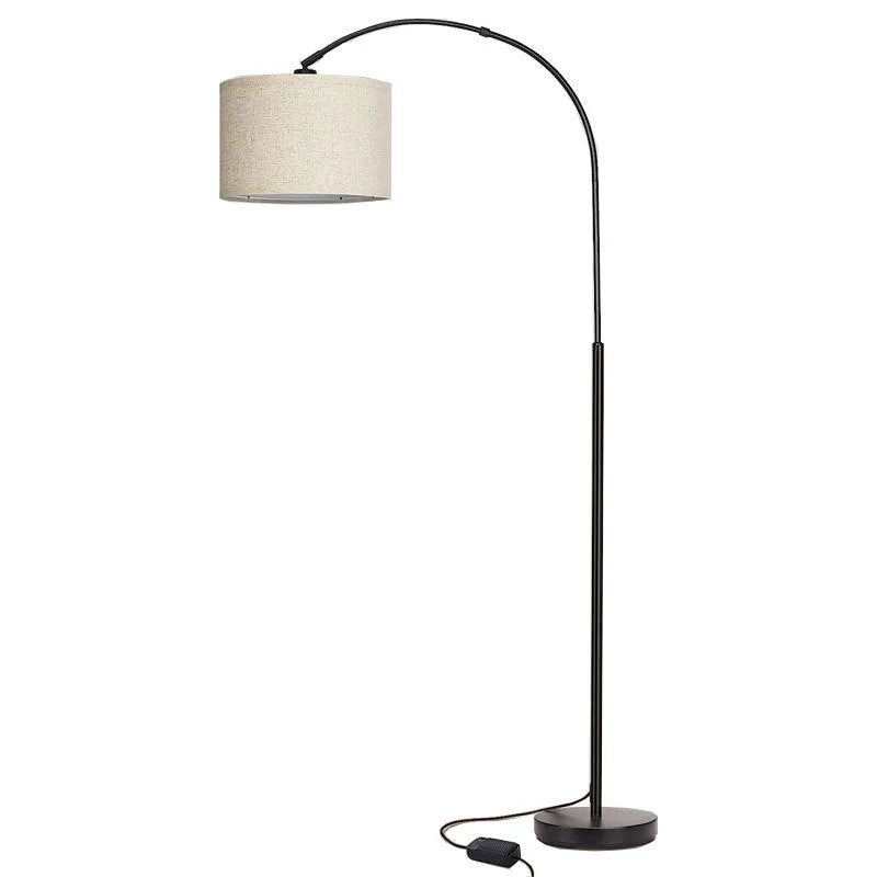 Modern minimalist fishing floor lamp with black fabric shade standing in a living room corner