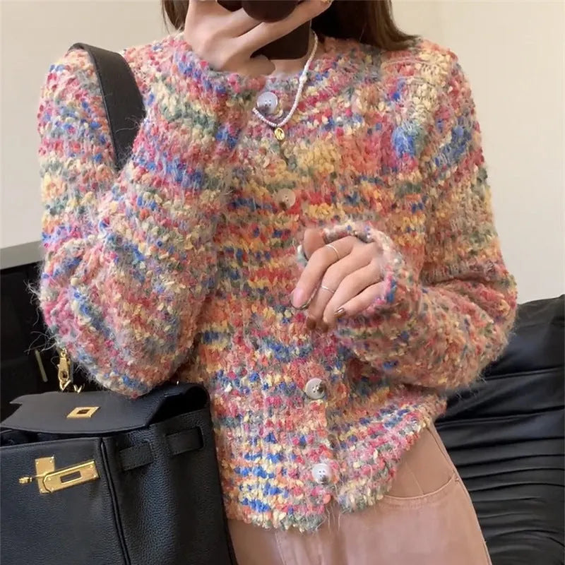 Green retro rainbow knitted cardigan sweater with a slim fit on a hanger.