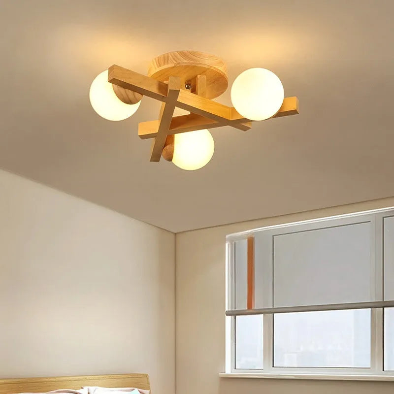 Scandinavian wooden-style ceiling light with three adjustable black lamp heads on angled arms