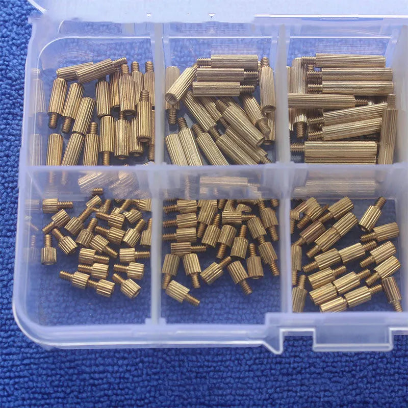 Gold-coloured 260-piece stainless steel screw nut and brass copper column set stored in a clear compartment box