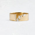 Gold-coloured women's ring with shining zircon stones on a copper band.