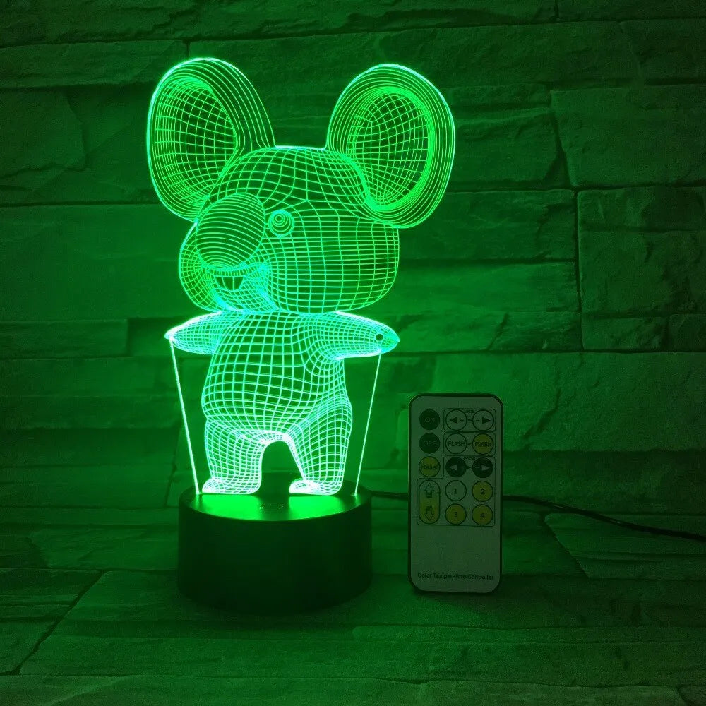 Koala-shaped night light with remote control showing seven colour options on a bedside table
