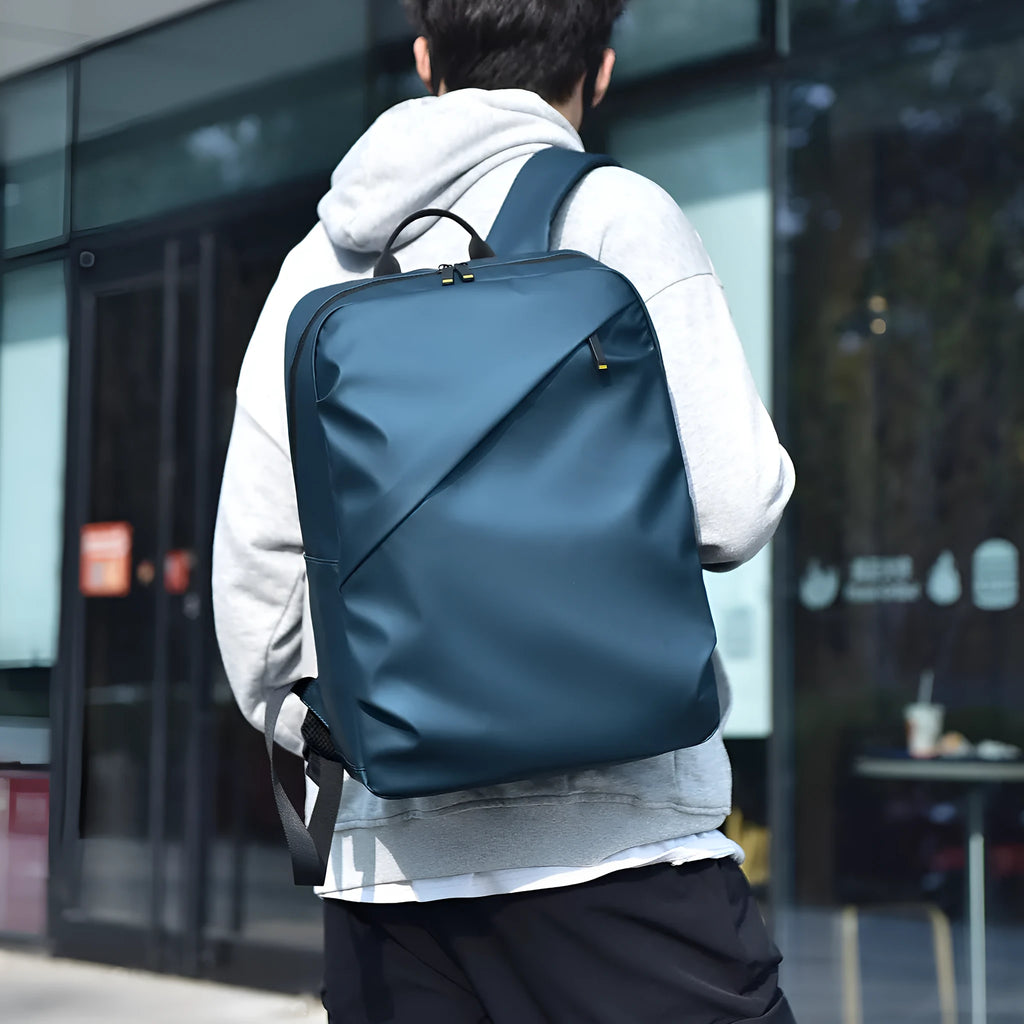 Waterproof PU leather laptop backpack in black, blue or grey with large capacity and laptop compartment