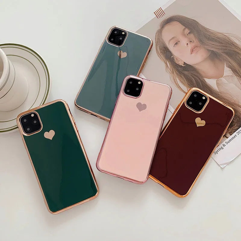 Solid colour TPU back cover case for iPhone on a table, showing blue, claret, pink, and green options.