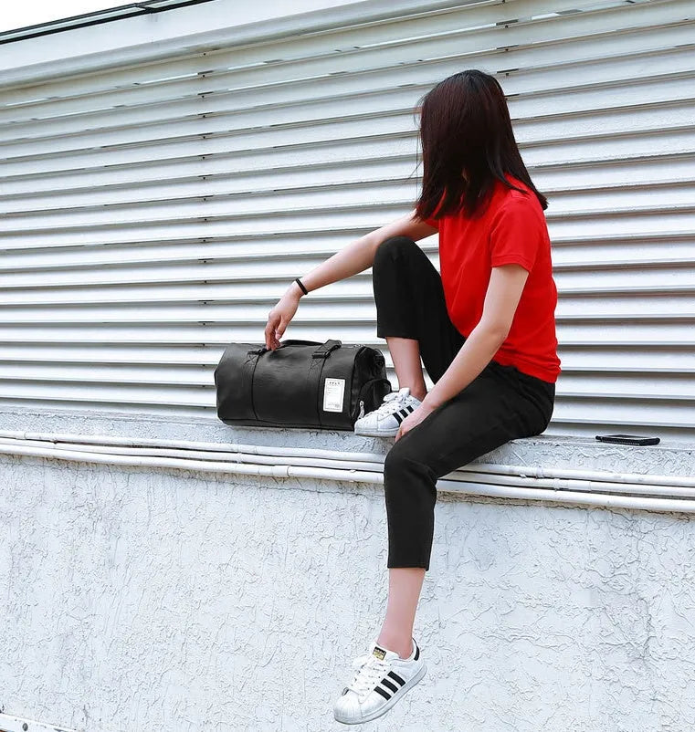 Black waterproof sports fitness bag with separate shoe compartment and diagonal shoulder strap.