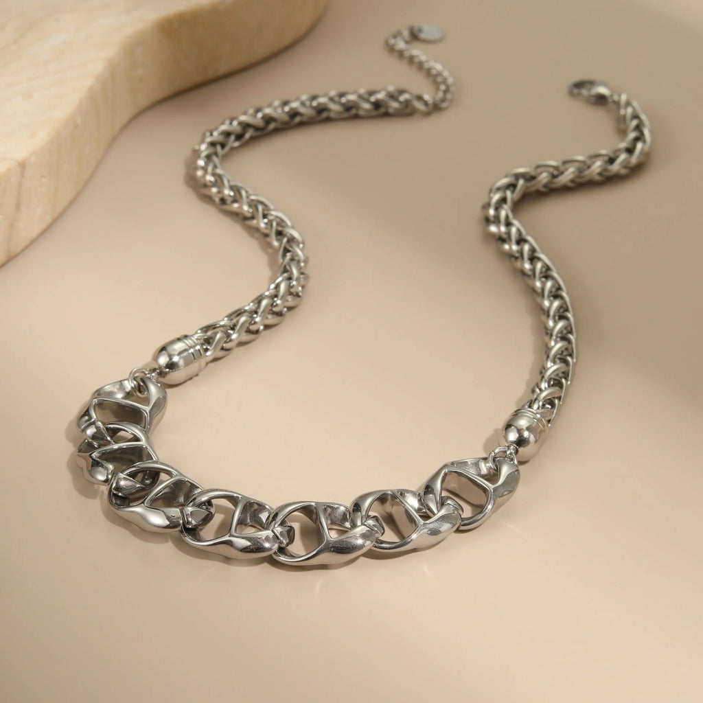 Stainless steel geometric pendant necklace with gold electroplated finish on a regular chain.