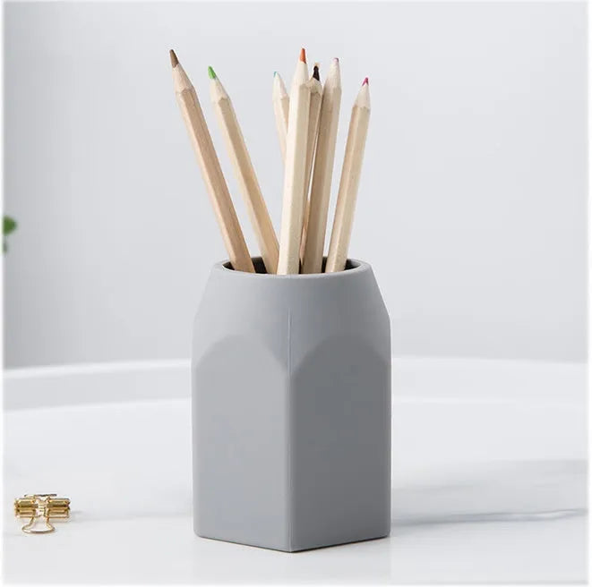 Round silicone pen holder 80x95mm in white on a desk holding pens and pencils