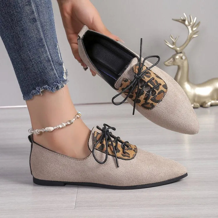 Beige leopard print women's pointed toe pumps with a rubber sole, shown in an extended size range.
