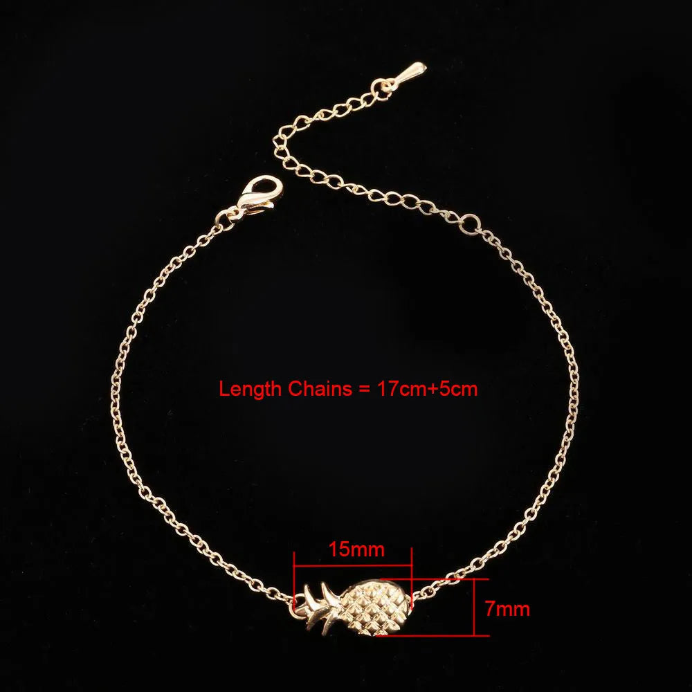 Gold tone alloy bracelet with a detailed pineapple charm on a simple bangle.