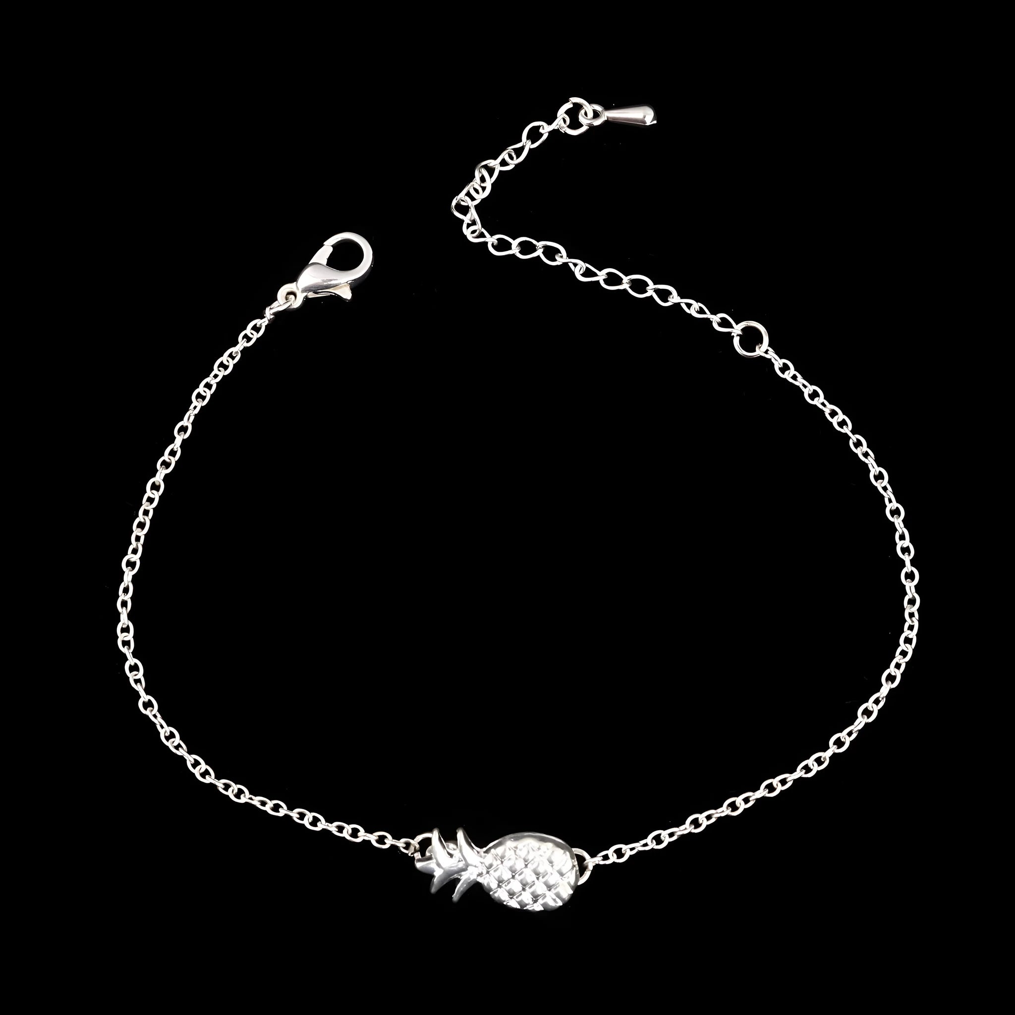 Gold tone alloy bracelet with a detailed pineapple charm on a simple bangle.