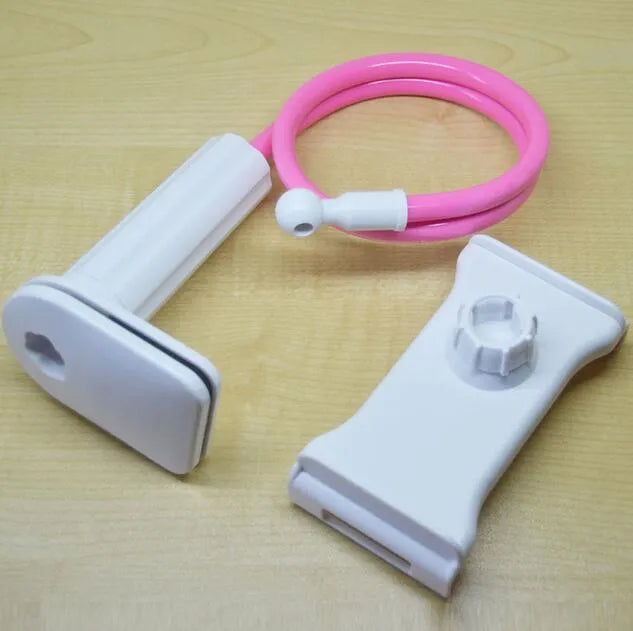 Black aluminium alloy bedside phone handset with a long arm and wide clamp, holding a mobile phone above a bed.