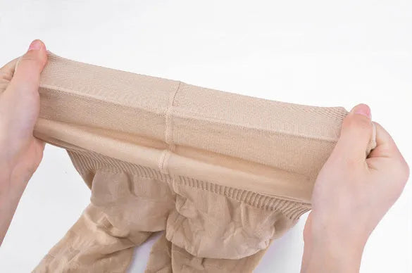 Black high-waisted seamless shapewear shorts for women laid flat on a neutral background.