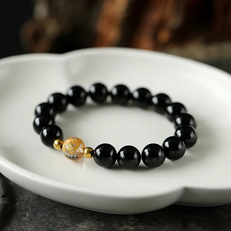 Unisex geometric bead bracelet with black obsidian agate and white crystal stones on a wrist
