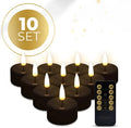 Four black S10 LED flameless tealight candles showing realistic flickering light.