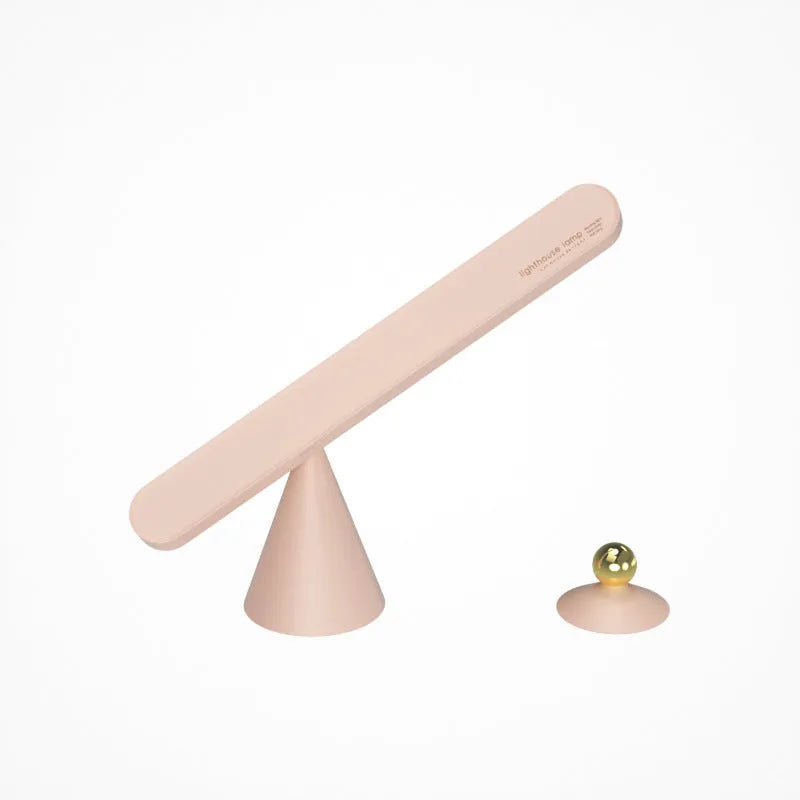 White geometric desk lamp with touch control and magnetic base on a wooden table.
