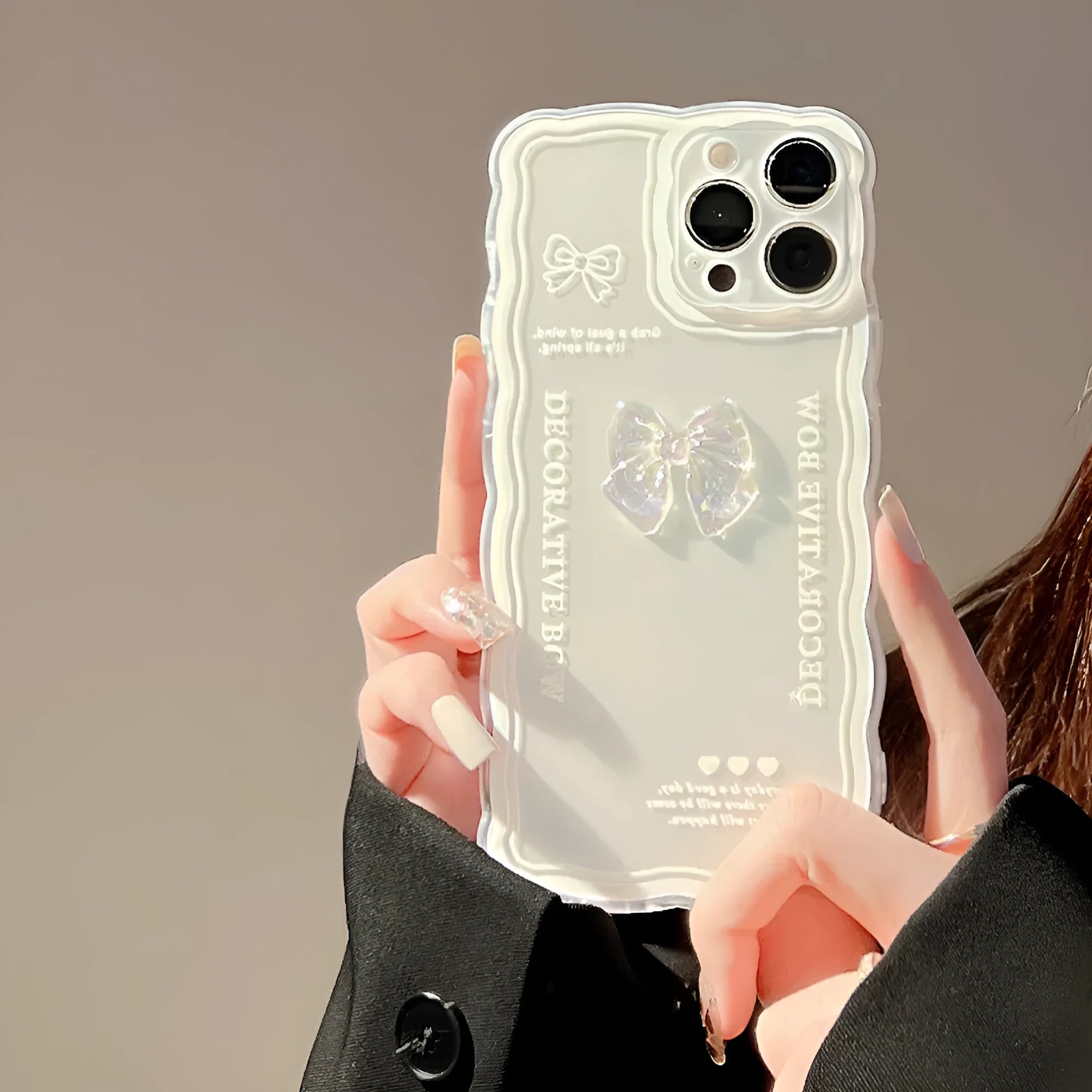 Transparent iPhone case with raised ice-through bow design and white love lanyard attachment