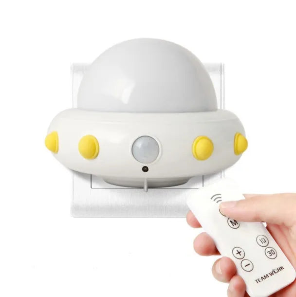 Remote control UFO-shaped bedside night light in blue, pink, or white with cartoon modern design