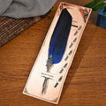 Vintage feather dip pen with zinc alloy holder in assorted colours on a wooden desk