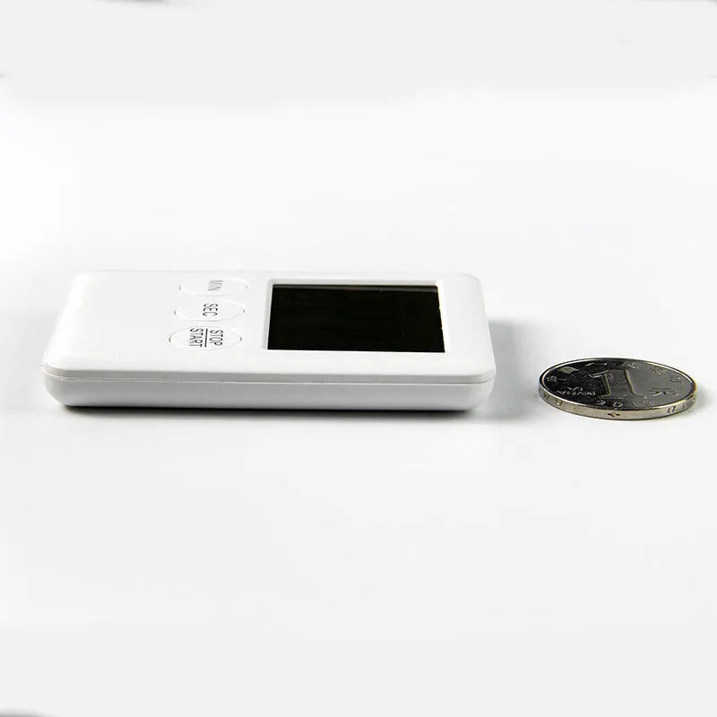 Black and white kitchen timer with magnetic backing showing count-up and countdown display