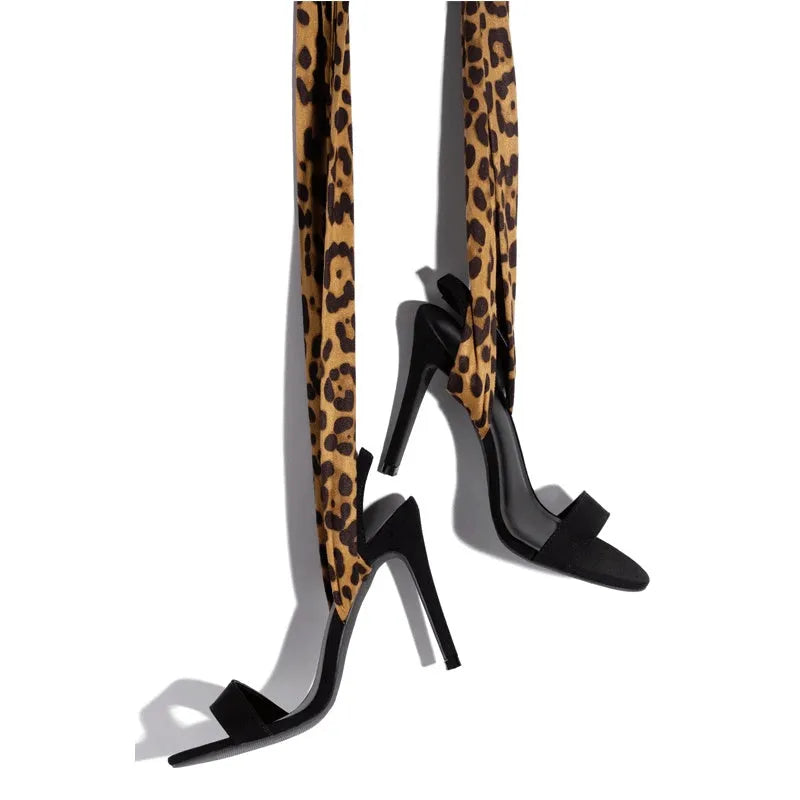 Light brown leopard print women's high heels with cross straps and an 8cm slim heel on a rubber sole.