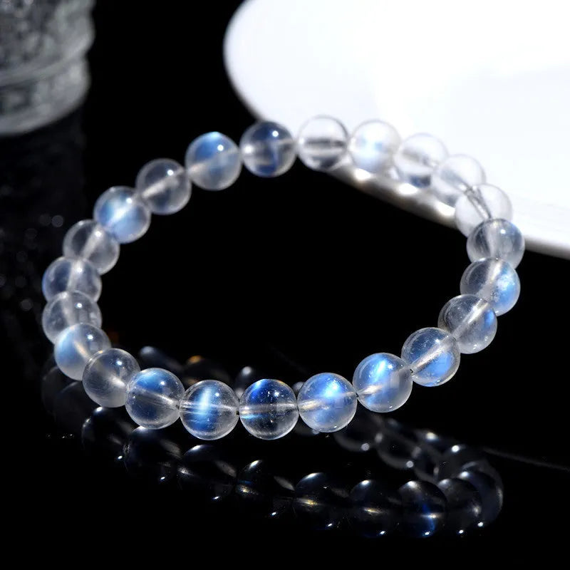 Natural cream coloured Blue Moonlight crystal bracelet on a wrist, showing minimalist unisex design.