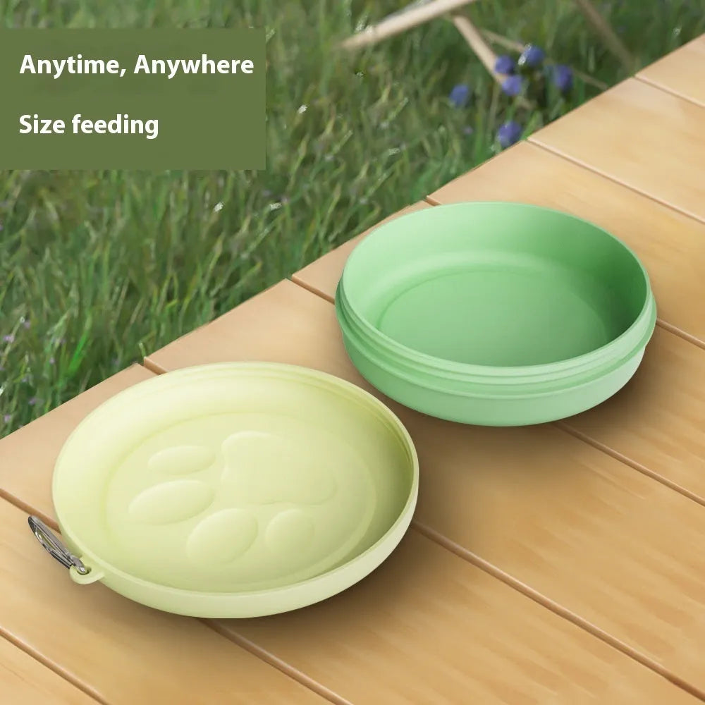 Collapsible portable dog bowl showing separate food and water compartments, in a two-tone light pink colour.