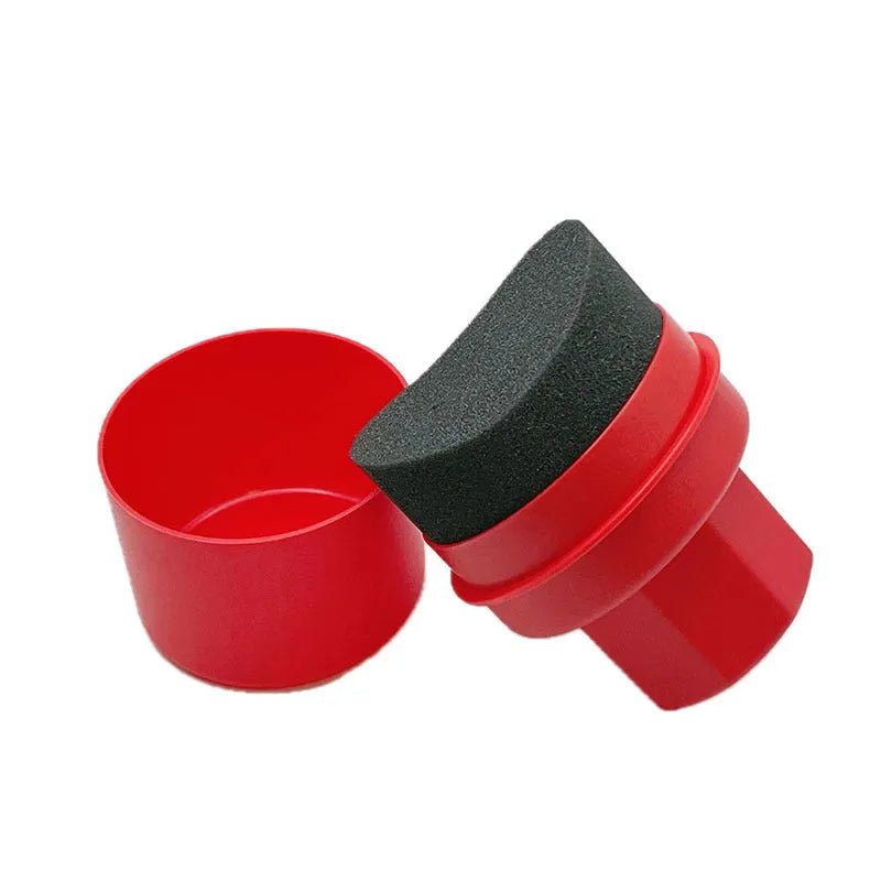 Black and red car tyre polishing sponge brushes with lids on a tyre, showing flat and curved sponge edges.