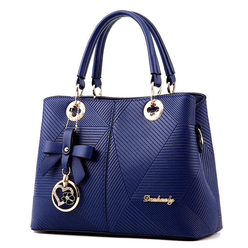 Structured black retro handbag with gold zip and adjustable shoulder strap on a table.