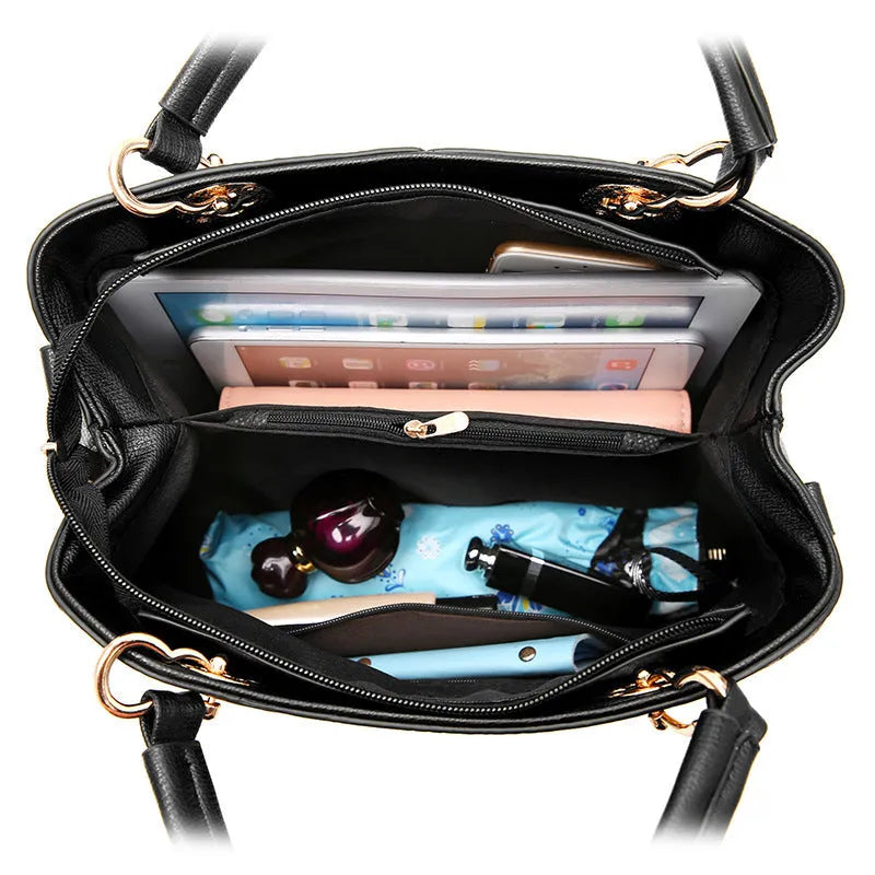 Structured black retro handbag with gold zip and adjustable shoulder strap on a table.
