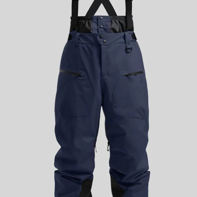 Man wearing black waterproof ski pants with adjustable ankle straps.
