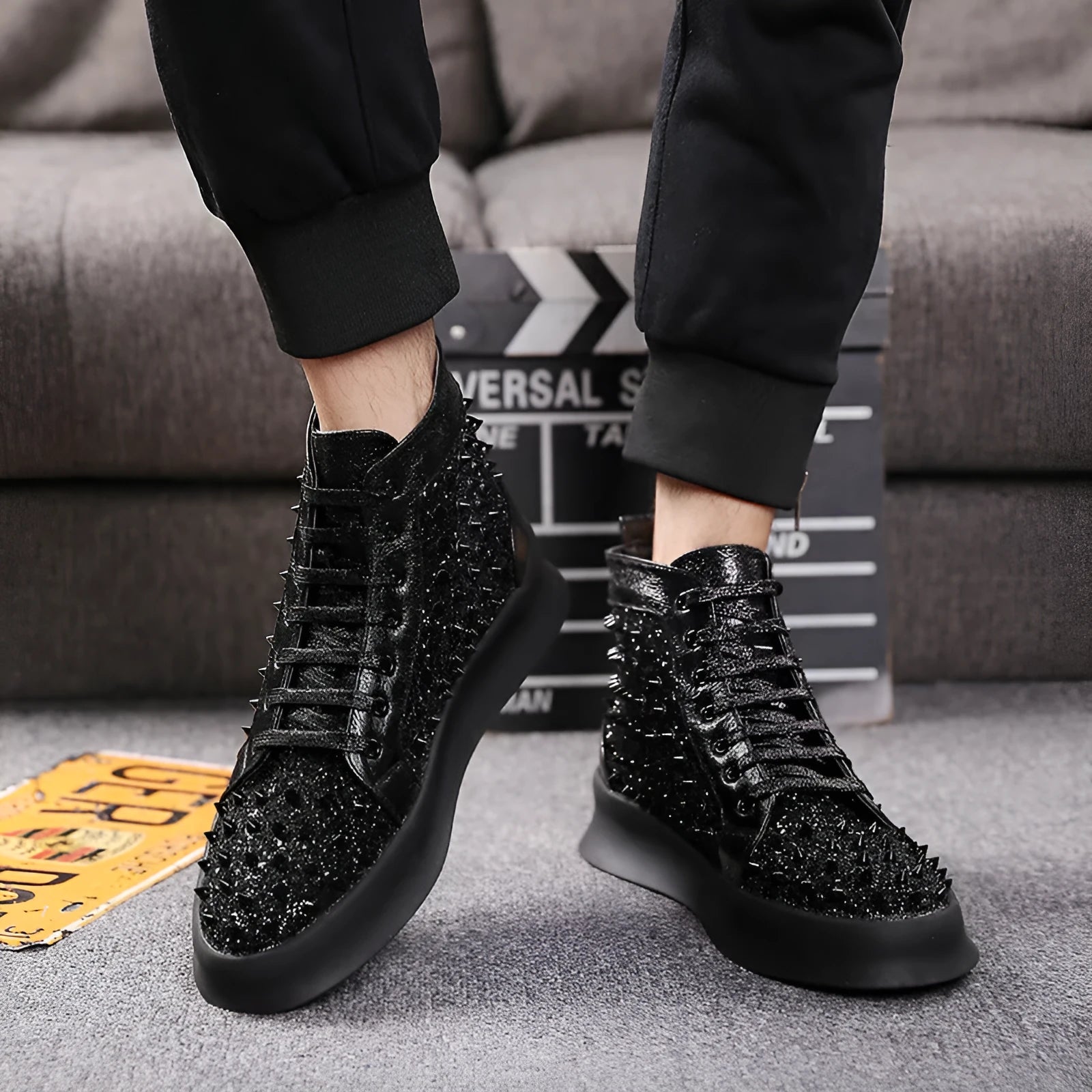 Men's black leather martin boots business dress shoes with rivets on a surface