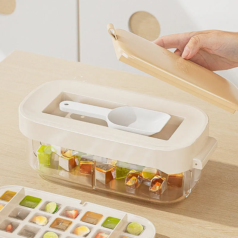 Blue high-capacity ice cube tray with silicone lid and ice scoop stored in its dedicated slot.