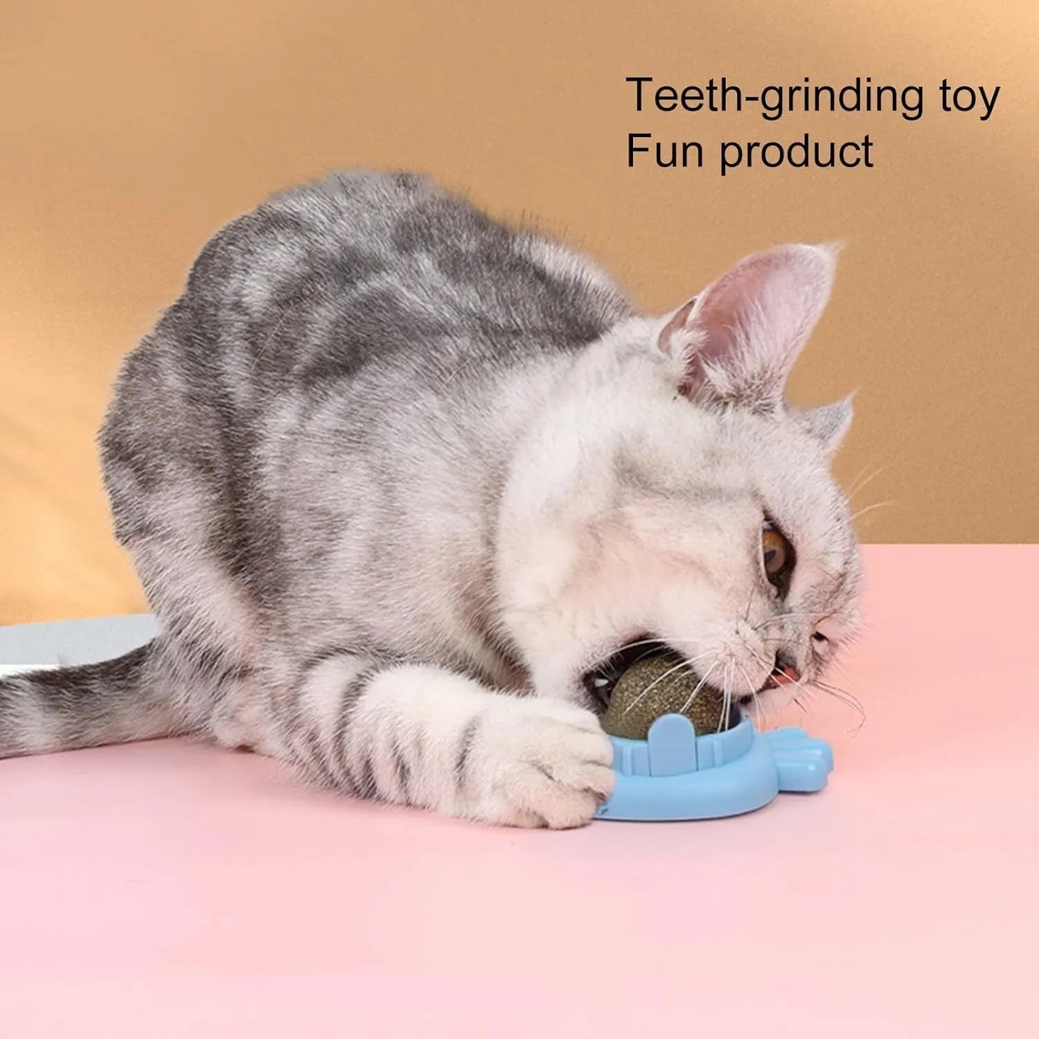 Blue carrot-shaped catnip ball toy with self-adhesive backing for wall mounting and cat teeth cleaning